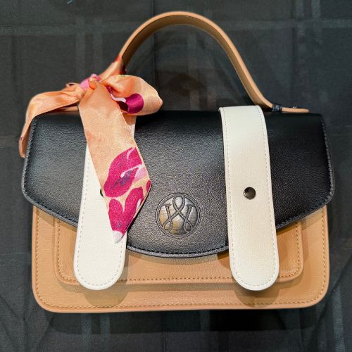 Brown, black, and white Waterloo Bags Purse styled with flower scarf bow