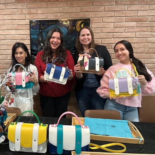 Group of ladies showing purses after a Waterloo Bags Galentine's Day party