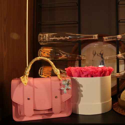 Pink Waterloo Bags purse with yellow scarf and balloon dog purse charm
